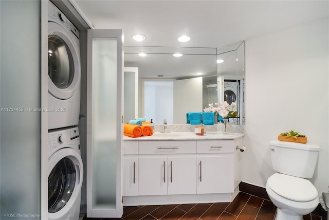 laundry room featuring stacked washer and dryer and sink