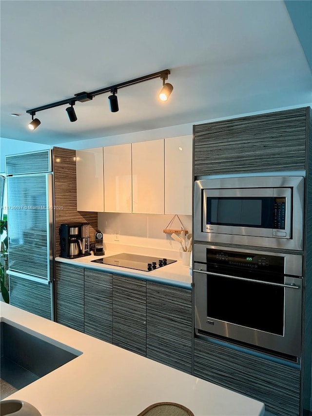 460 NE 28th St Unit 2503, Miami, FL 33137 - kitchen featuring appliances with stainless steel finishes, rail lighting, light countertops, and modern cabinets