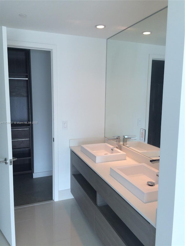 bathroom with tile patterned flooring and vanity