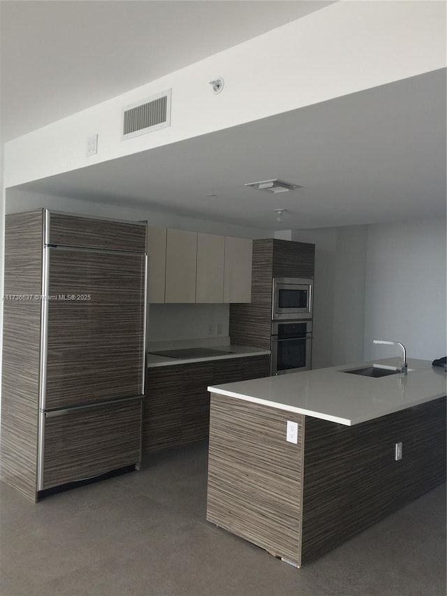 460 NE 28th St Unit 2503, Miami, FL 33137 - kitchen featuring appliances with stainless steel finishes, modern cabinets, light countertops, and light carpet