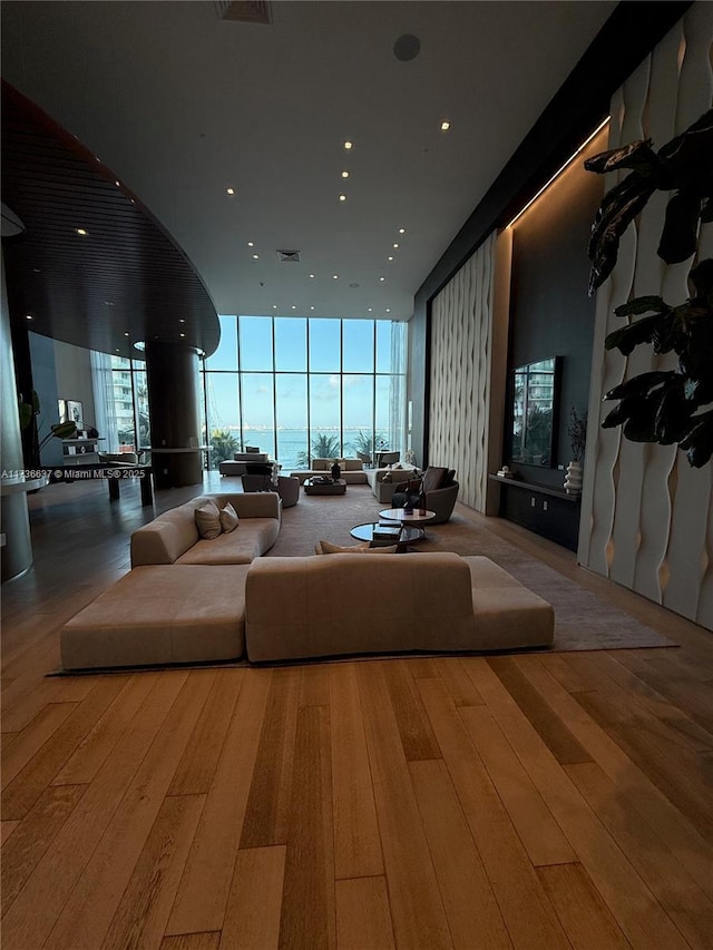 living room with floor to ceiling windows and light wood-type flooring