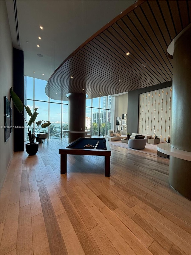 playroom featuring pool table, a wall of windows, and light hardwood / wood-style floors