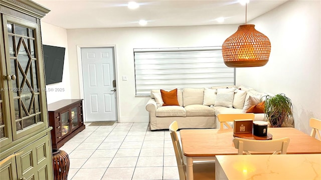 living area with light tile patterned flooring and baseboards