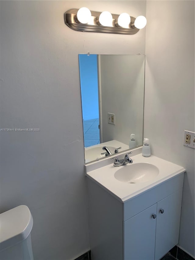 bathroom featuring vanity and toilet