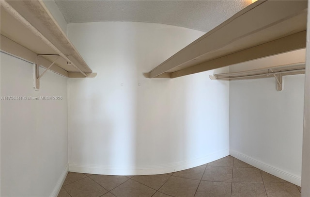 spacious closet with tile patterned floors