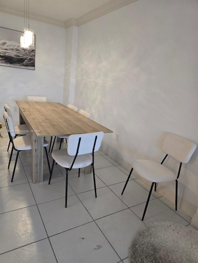 tiled dining area featuring crown molding