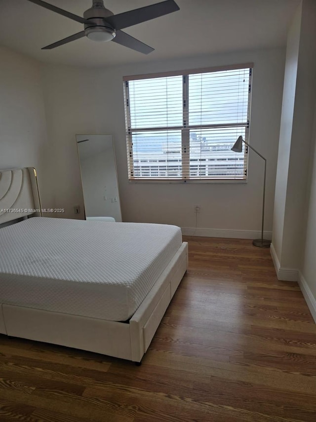 bedroom with ceiling fan and dark hardwood / wood-style flooring