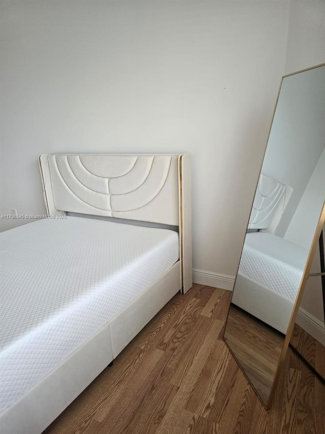 bedroom with hardwood / wood-style flooring