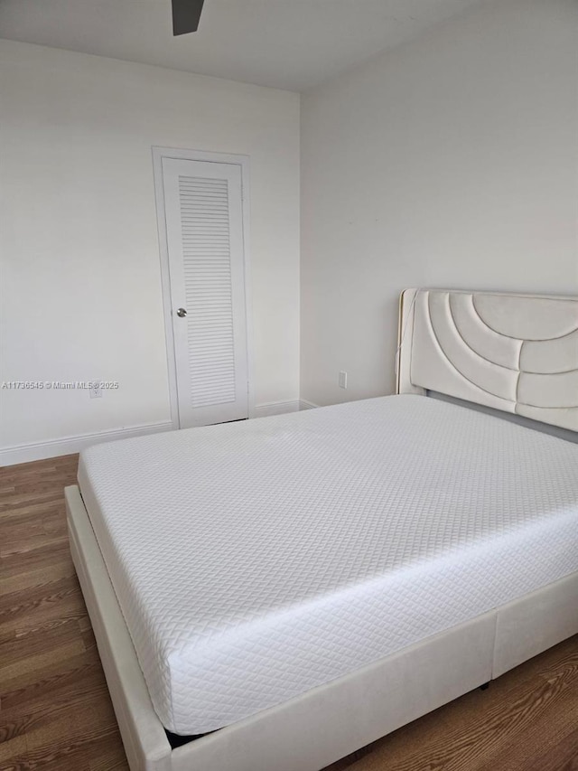 bedroom with dark wood-type flooring