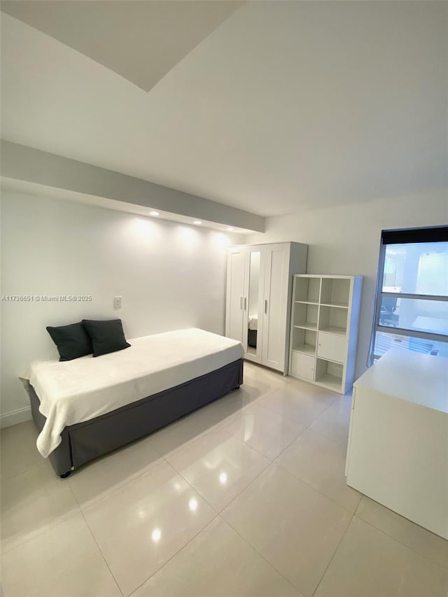 unfurnished bedroom featuring light tile patterned floors