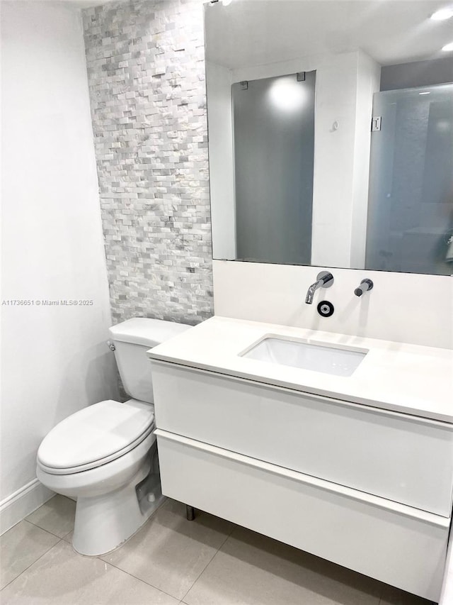 bathroom featuring vanity, toilet, and tile patterned flooring