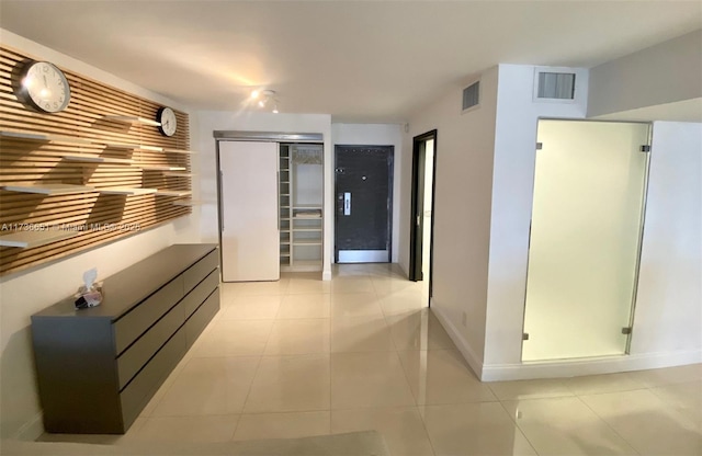 hallway featuring light tile patterned floors