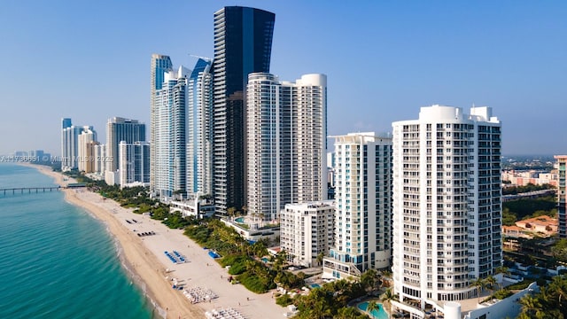 view of city featuring a beach view and a water view