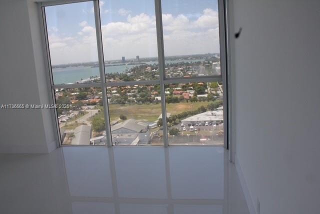 entryway with a water view and a view of city