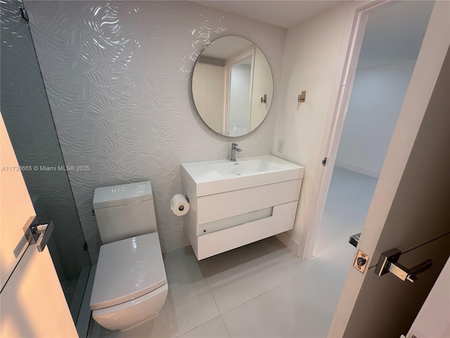bathroom with vanity, tile patterned flooring, and toilet