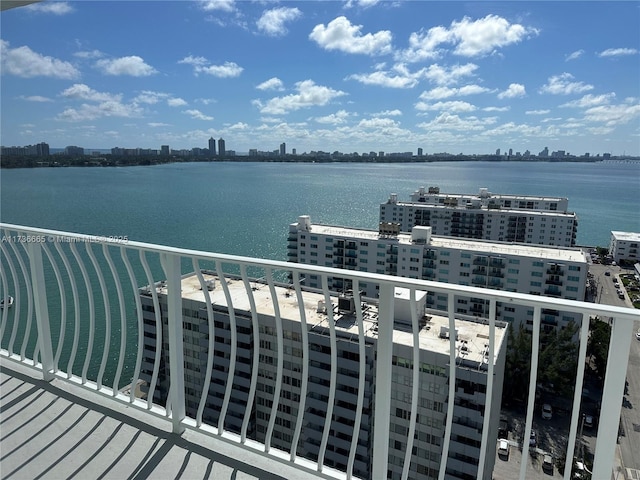 balcony featuring a water view and a view of city