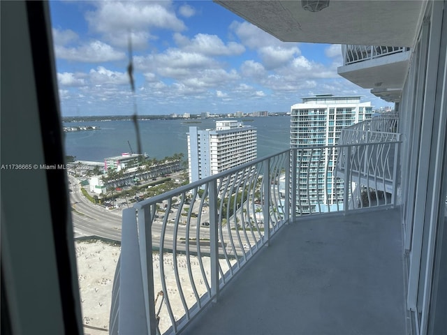 balcony featuring a view of city and a water view