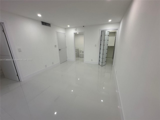 basement with light tile patterned floors, recessed lighting, and visible vents