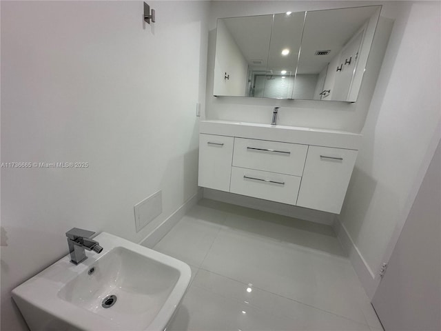 bathroom with a sink, tile patterned flooring, and visible vents