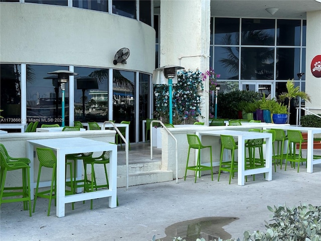 view of community with outdoor dry bar and a patio