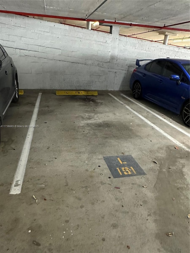 parking deck featuring concrete block wall