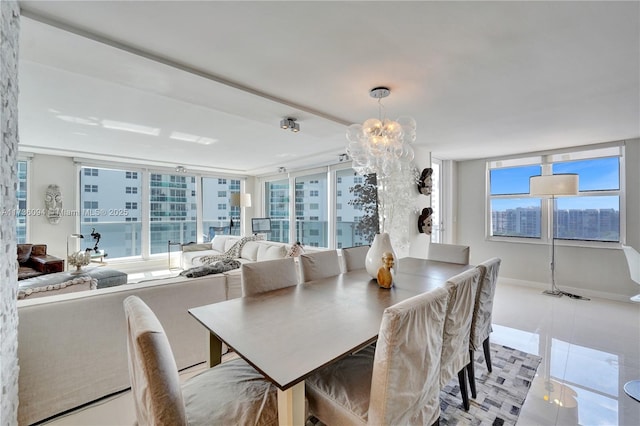 tiled dining room with plenty of natural light and a chandelier