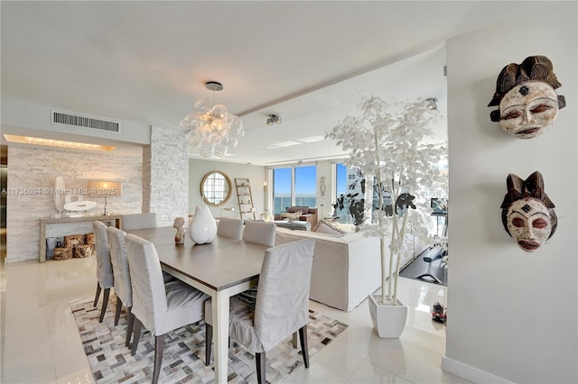 dining room with an inviting chandelier and light tile patterned floors