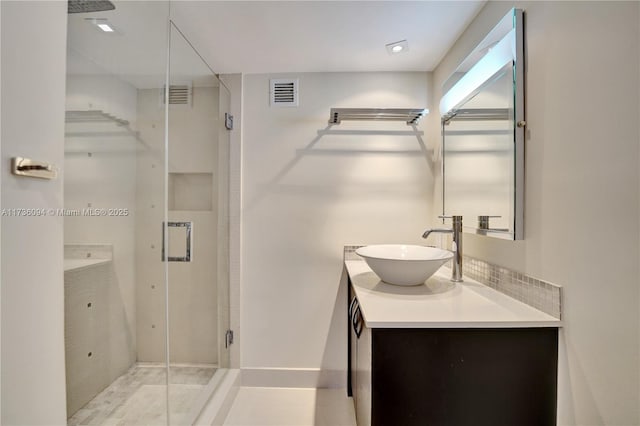 bathroom with vanity and a shower with door