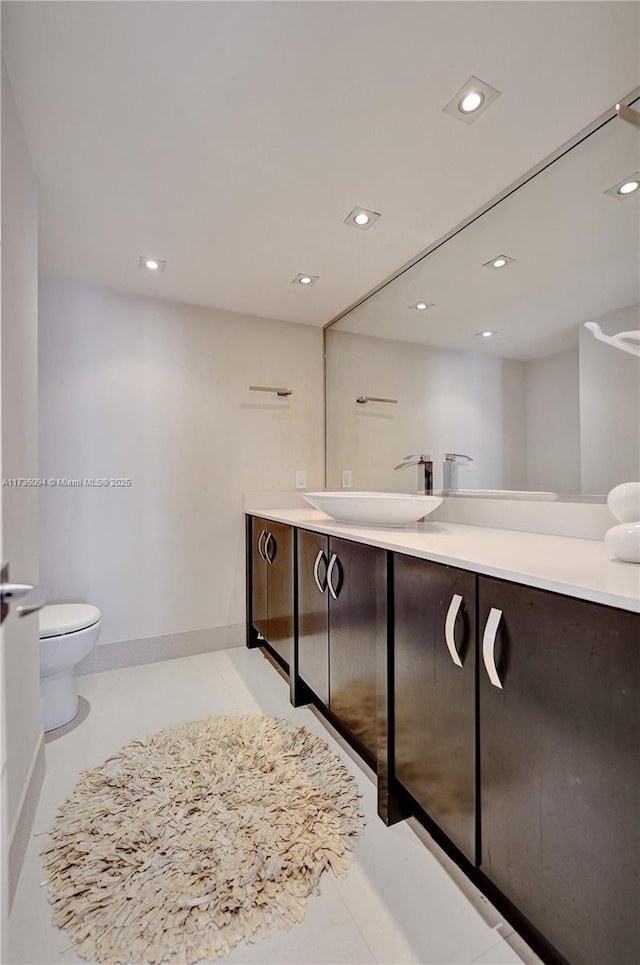 bathroom with vanity, toilet, and tile patterned flooring