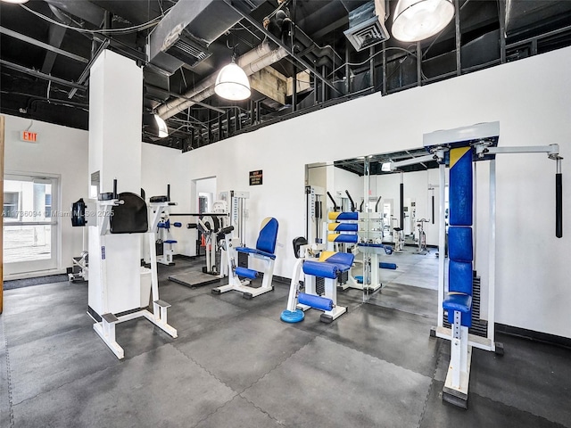 gym with a towering ceiling