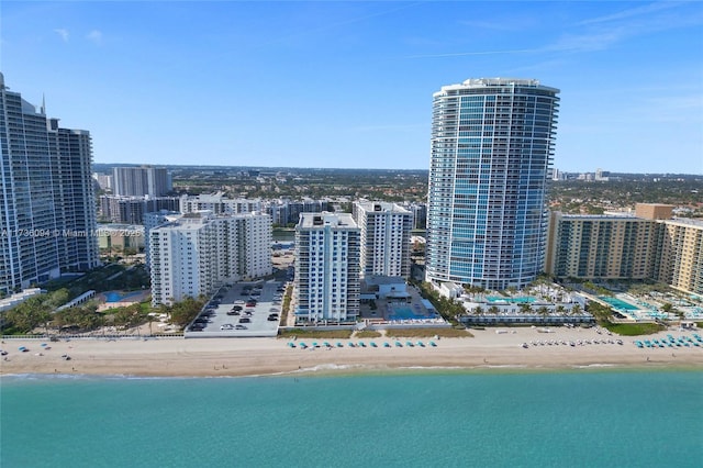 drone / aerial view with a water view and a view of the beach