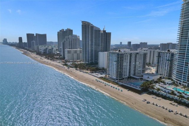 birds eye view of property with a beach view and a water view