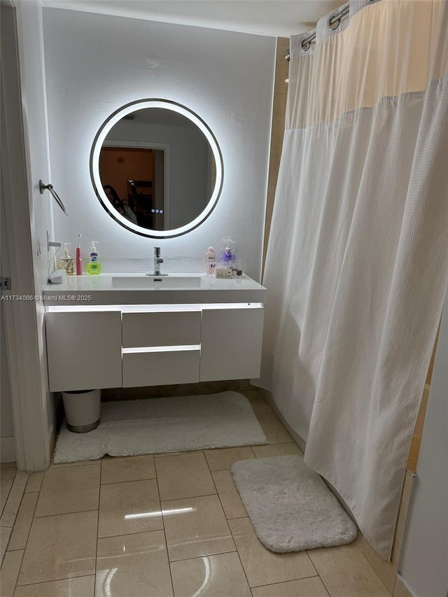 bathroom with vanity, curtained shower, and tile patterned flooring