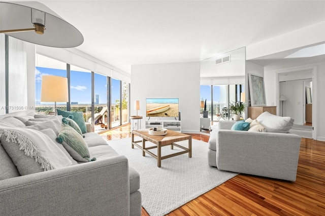 living room with hardwood / wood-style flooring and expansive windows