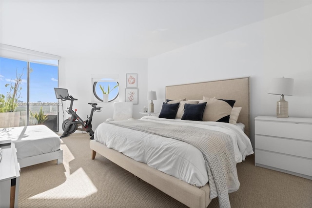 carpeted bedroom featuring a wall of windows