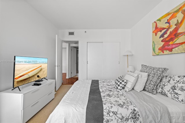 carpeted bedroom with a closet