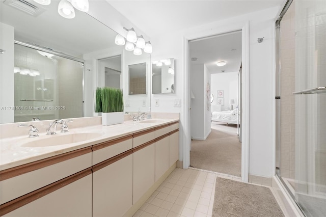 bathroom featuring tile patterned floors, vanity, and a shower with shower door