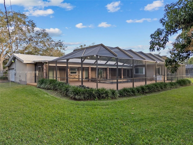 rear view of house with a yard, a lanai, and a patio