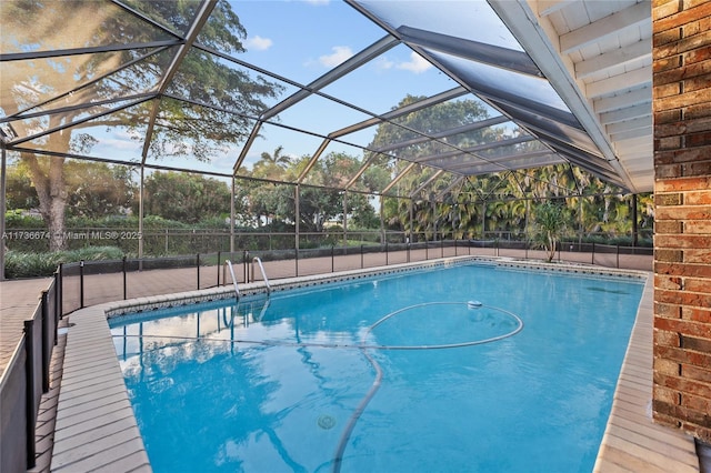 view of swimming pool featuring glass enclosure