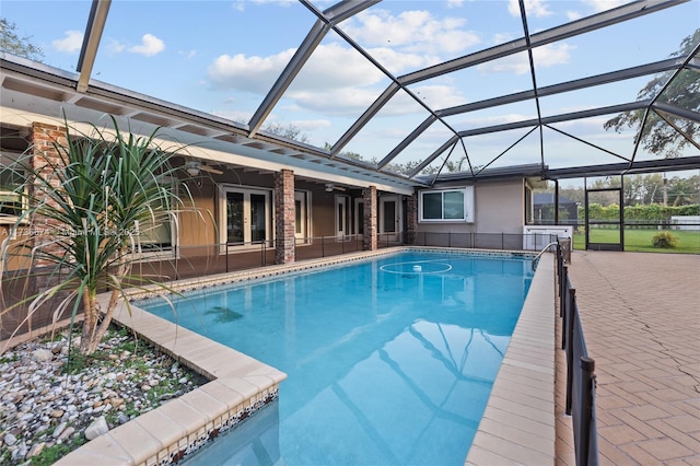 view of swimming pool featuring a patio and a lanai