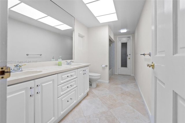 bathroom featuring vanity, tile patterned flooring, and toilet