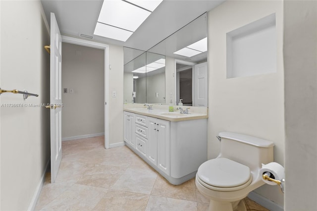 bathroom featuring tile patterned flooring, vanity, and toilet