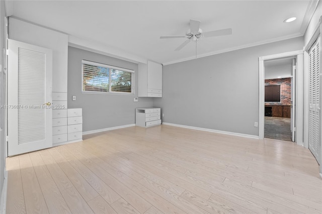 interior space with ceiling fan, ornamental molding, and light hardwood / wood-style flooring