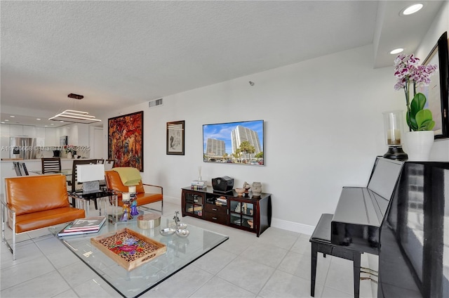 tiled living room featuring a textured ceiling