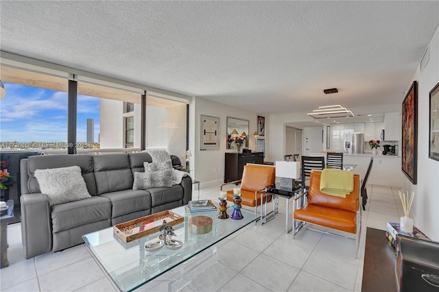 living room with light tile patterned floors and a textured ceiling