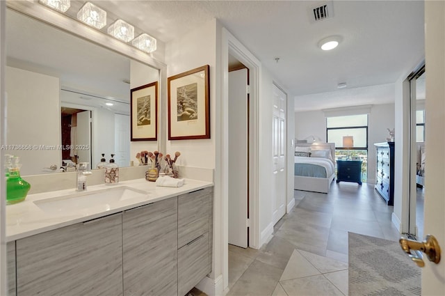 bathroom featuring tile patterned flooring and vanity