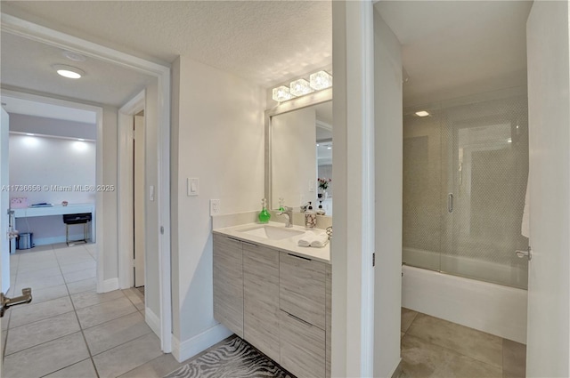 bathroom featuring enclosed tub / shower combo, vanity, tile patterned flooring, and a textured ceiling