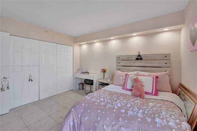 bedroom featuring light tile patterned floors and a closet