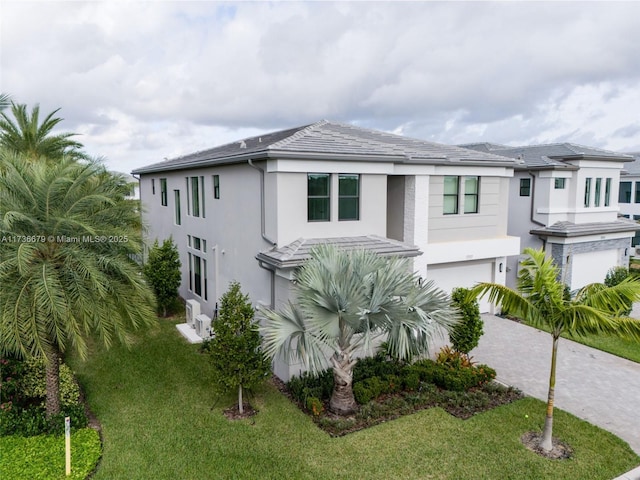 view of front of house with a garage and a front lawn