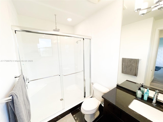 bathroom featuring walk in shower, vanity, and toilet